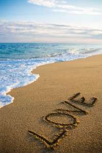 love concept - beach background with word love written in sand